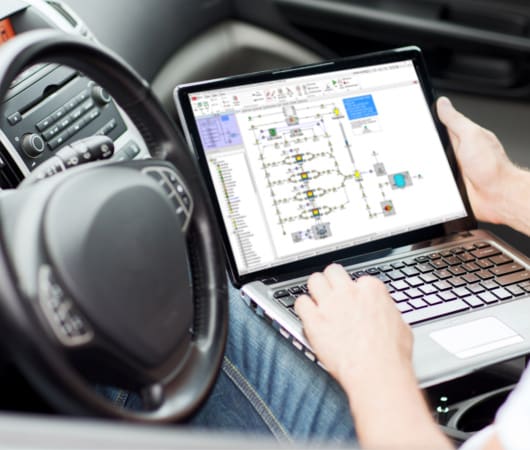 transportation and vehicle concept – man using laptop computer in car